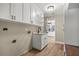 Laundry room features granite countertop, white cabinets, and luxury vinyl plank flooring at 1815 Big Oak Ln, Kissimmee, FL 34746