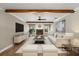 This living room features wood-look floors, a fireplace, a ceiling fan, and is fully staged with furniture at 1815 Big Oak Ln, Kissimmee, FL 34746