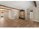 Inviting living room showcasing wood floors, beams, display case, and staircase access at 1815 Big Oak Ln, Kissimmee, FL 34746