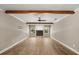 Spacious living room features wood-look floors, wood beam, fireplace, ceiling fan, and abundant natural light at 1815 Big Oak Ln, Kissimmee, FL 34746