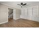 Office space featuring built-in cabinets, hardwood floors, and a ceiling fan at 1815 Big Oak Ln, Kissimmee, FL 34746