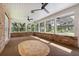 Bright sunroom featuring brick walls, ceiling fans, and large windows offering abundant natural light and outdoor views at 1815 Big Oak Ln, Kissimmee, FL 34746