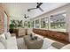 Bright sunroom featuring brick walls, beamed ceiling, several windows, and patio furniture at 1815 Big Oak Ln, Kissimmee, FL 34746