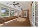 Spacious sunroom featuring brick walls, ceiling fans, and multiple access points to the outdoor areas at 1815 Big Oak Ln, Kissimmee, FL 34746