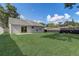 Great backyard features a patio, expansive lawn, and privacy fencing at 1821 Geigel Ave, Orlando, FL 32806