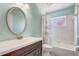 Cozy bathroom with white tile, vanity, and shower/tub combination at 1821 Geigel Ave, Orlando, FL 32806