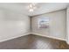 Bedroom with light grey walls, wood-look tile flooring, and a bright window at 1821 Geigel Ave, Orlando, FL 32806