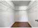 Walk-in closet featuring wire shelving and wood-look flooring providing ample storage space at 1821 Geigel Ave, Orlando, FL 32806