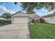Charming single-story home with a well-manicured lawn, vibrant landscaping, and a two-car garage at 1821 Geigel Ave, Orlando, FL 32806