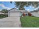 Charming single-story home with a well-maintained lawn and a two-car garage at 1821 Geigel Ave, Orlando, FL 32806