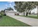 A wide shot of the front of the house with a driveway, landscaping, and picket fence at 1821 Geigel Ave, Orlando, FL 32806