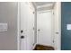 Hallway features wood-look floors and white doors, offering a warm welcome at 1821 Geigel Ave, Orlando, FL 32806