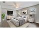 Staged main bedroom with modern furniture, neutral decor, and ceiling fan at 1821 Geigel Ave, Orlando, FL 32806