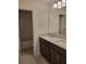Clean bathroom with a double vanity, modern fixtures, a large mirror, and tile flooring at 1855 Church Lake St, Groveland, FL 34736