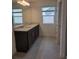 Bathroom with double sink vanity, granite countertop, and a large mirror at 1855 Church Lake St, Groveland, FL 34736