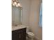 Elegant bathroom with a granite vanity, modern fixtures, ample lighting, and a toilet at 1855 Church Lake St, Groveland, FL 34736