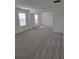 Spacious bedroom with neutral carpet, large windows, and bright natural light throughout at 1855 Church Lake St, Groveland, FL 34736