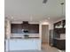 Spacious kitchen with stainless steel appliances, subway tile backsplash, an island with bar seating, and modern lighting at 1855 Church Lake St, Groveland, FL 34736