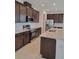 Modern kitchen features stainless steel appliances, granite countertops, tile backsplash, and dark wood cabinetry at 1855 Church Lake St, Groveland, FL 34736