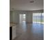 Bright living room with tile flooring, sliding glass doors to the backyard, and ample natural light at 1855 Church Lake St, Groveland, FL 34736