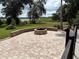 Inviting backyard with brick patio, fire pit, and serene water view at 1865 S Tanner Ct, Deltona, FL 32738