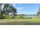 Lush backyard leading to a tranquil lake, perfect for nature enthusiasts at 1865 S Tanner Ct, Deltona, FL 32738
