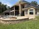 Beautiful backyard featuring a brick fire pit, outdoor seating, and screened-in lanai at 1865 S Tanner Ct, Deltona, FL 32738