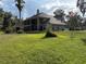 Expansive backyard with lush green lawn and mature trees offers a private retreat at 1865 S Tanner Ct, Deltona, FL 32738