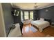 Bedroom with bay window sitting area, hardwood floors, and a ceiling fan at 1865 S Tanner Ct, Deltona, FL 32738