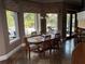 Open dining area with large windows overlooking the pool, and seating for six around a wooden table at 1865 S Tanner Ct, Deltona, FL 32738