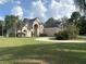 Spacious home with a circular driveway, manicured lawn, and beautiful, mature trees at 1865 S Tanner Ct, Deltona, FL 32738