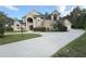 Elegant home featuring a large circular driveway, manicured lawn, and tasteful landscaping at 1865 S Tanner Ct, Deltona, FL 32738