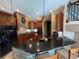 Spacious kitchen featuring dark cabinetry, granite countertops, island with seating, and stainless steel appliances at 1865 S Tanner Ct, Deltona, FL 32738