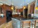 Well-equipped kitchen with stone detailing, black appliances, and a large island with barstool seating at 1865 S Tanner Ct, Deltona, FL 32738