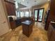 Bright kitchen with a kitchen island, stainless steel appliances and access to an outdoor patio and grill at 1865 S Tanner Ct, Deltona, FL 32738