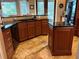 Kitchen with ample counter space, wooden cabinets, an island and black appliances at 1865 S Tanner Ct, Deltona, FL 32738