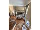 Open-concept living room boasts wood floors, stone fireplace, and large windows for natural light at 1865 S Tanner Ct, Deltona, FL 32738
