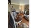 Spacious living room with wood floors, fireplace, and staircase leading to the second floor at 1865 S Tanner Ct, Deltona, FL 32738
