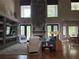 Spacious living room with high ceilings, stone fireplace, and large windows at 1865 S Tanner Ct, Deltona, FL 32738