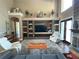 Elegant living room featuring custom built-ins, stone accents, and ample seating at 1865 S Tanner Ct, Deltona, FL 32738