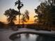 Backyard pool with a relaxing view of the surrounding lake at sunset at 1865 S Tanner Ct, Deltona, FL 32738