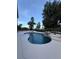 Private backyard pool featuring a rock waterfall and scenic views at 1865 S Tanner Ct, Deltona, FL 32738