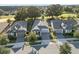 An aerial view shows the home with a well-manicured lawn and a paver driveway at 1962 Flora Pass Pl, Kissimmee, FL 34747