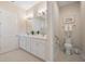 Clean bathroom with double sinks, a toilet, and a glass shower, perfect for modern living at 1962 Flora Pass Pl, Kissimmee, FL 34747