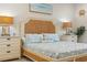 Bright bedroom featuring a wicker headboard, matching nightstands, and coastal-themed decor for a relaxing retreat at 1962 Flora Pass Pl, Kissimmee, FL 34747