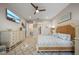 Well-lit bedroom with a TV, wicker headboard and carpet. Doorways lead to the closet and ensuite bathroom at 1962 Flora Pass Pl, Kissimmee, FL 34747