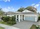 Charming single-story home with a gray brick driveway, a two-car garage, and a cozy front porch at 1962 Flora Pass Pl, Kissimmee, FL 34747