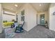 Inviting front porch with chairs, stylish brick flooring, and a charming front door, creating a welcoming entrance at 1962 Flora Pass Pl, Kissimmee, FL 34747