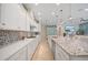 Spacious kitchen with stainless steel appliances, granite countertops, mosaic backsplash, and wood flooring at 1962 Flora Pass Pl, Kissimmee, FL 34747