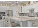 Bright kitchen features a large island, stainless steel appliances, white cabinets, and mosaic backsplash at 1962 Flora Pass Pl, Kissimmee, FL 34747